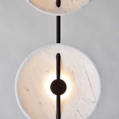 Modern ceiling light fixture with marble-like finish and black accents on a neutral background