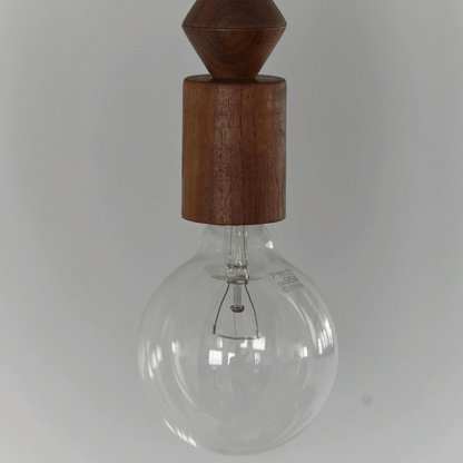 Clear glass light bulb with wooden top on a white background