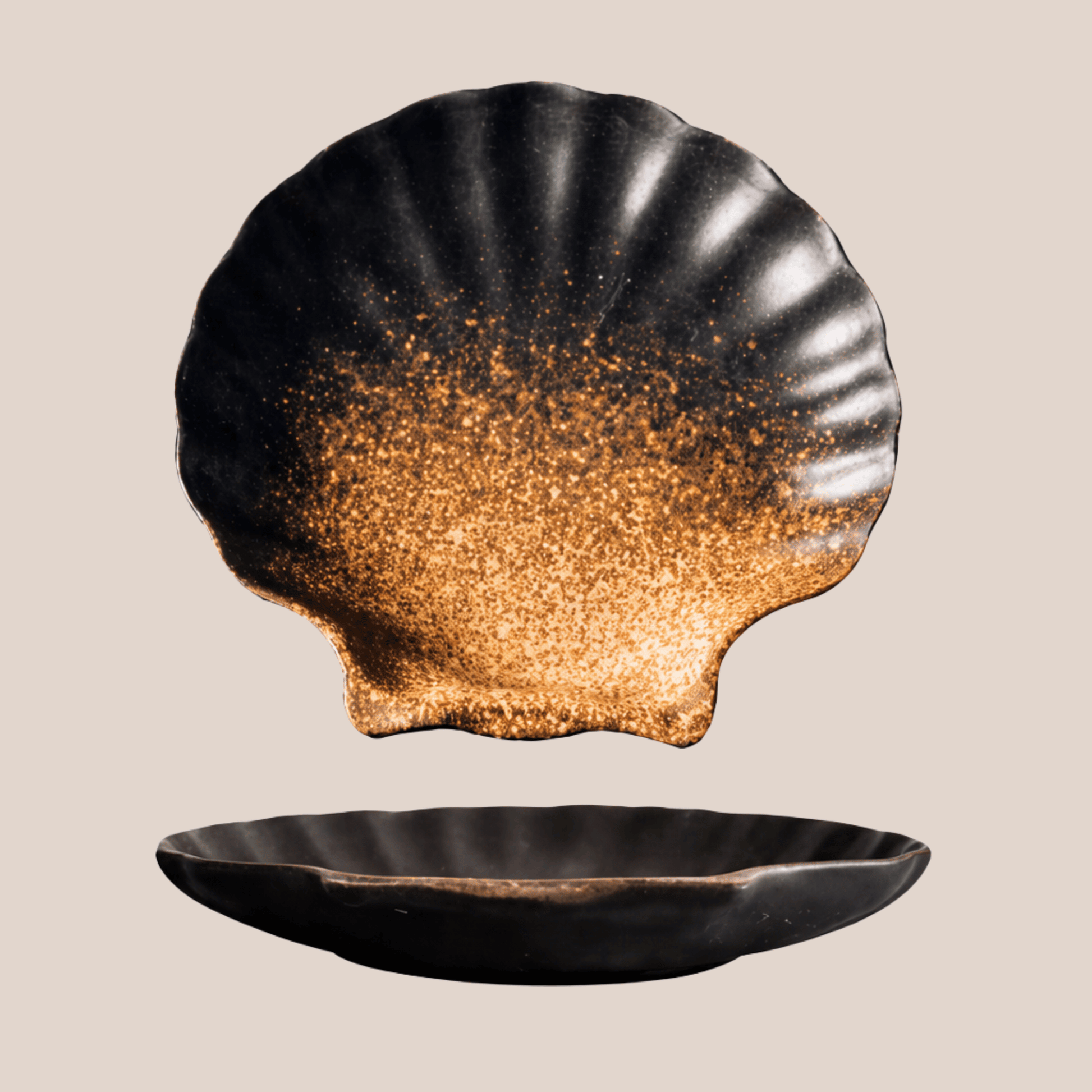 Black shell-shaped dish with gold interior on a beige background