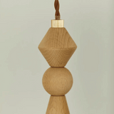 Wooden pendant light with geometric design on a plain background