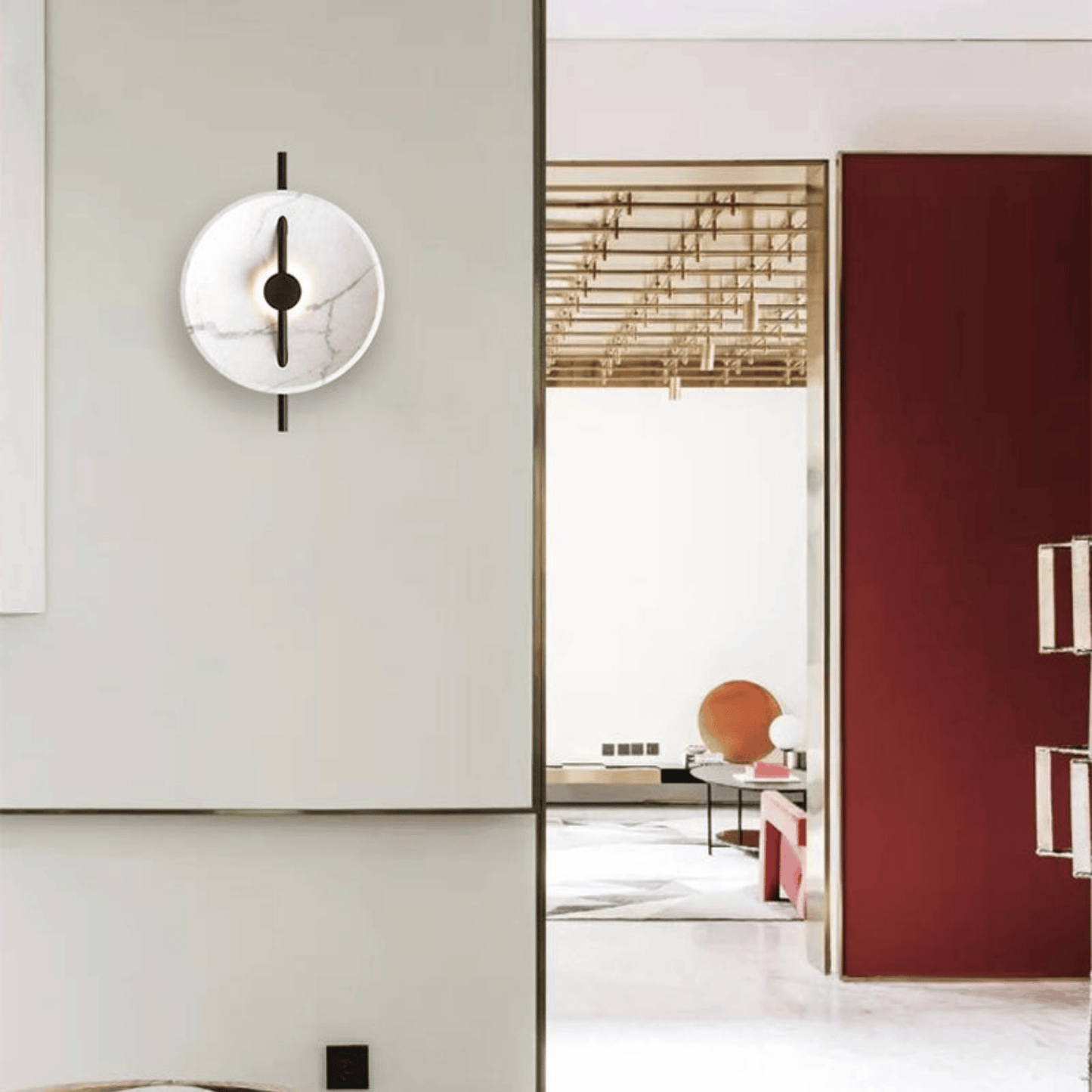 Modern wall clock on a light gray wall with a blurred room in the background