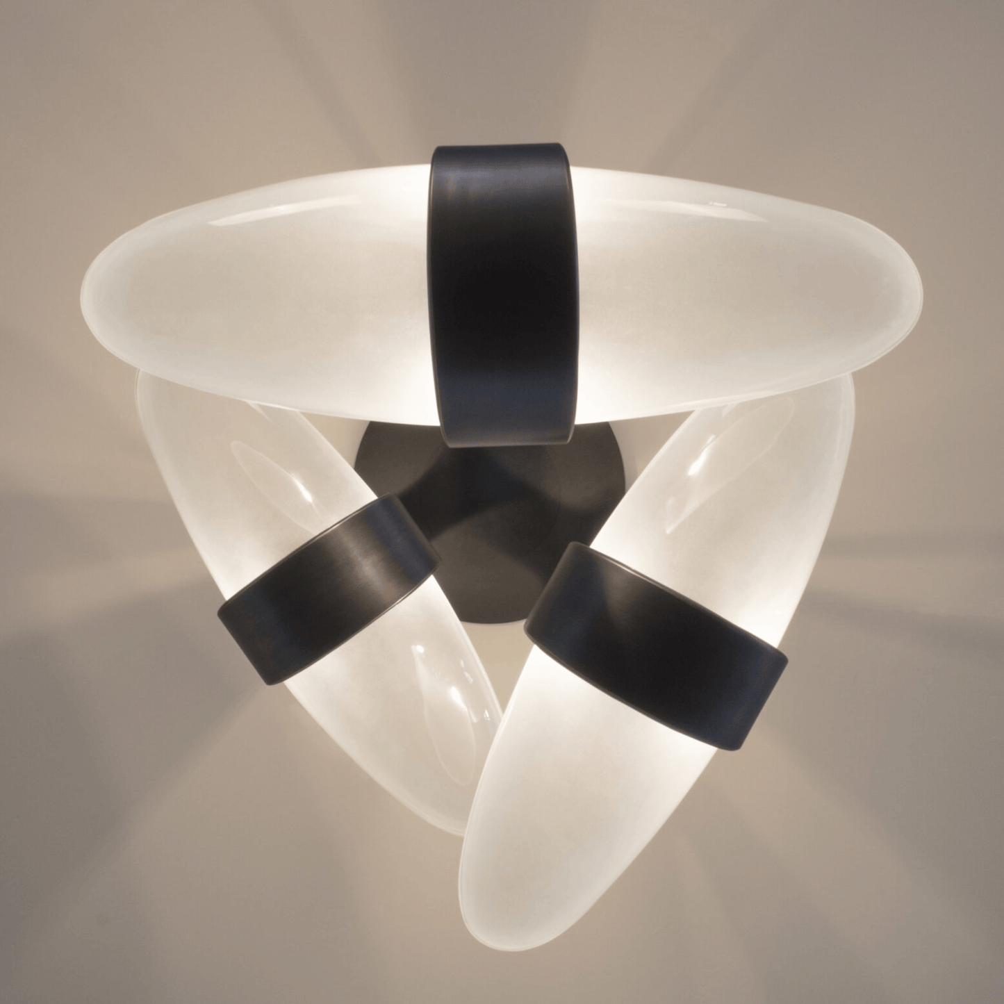 Modern ceiling light fixture with white and black design on a neutral background