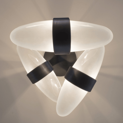 Modern ceiling light fixture with white and black design on a neutral background