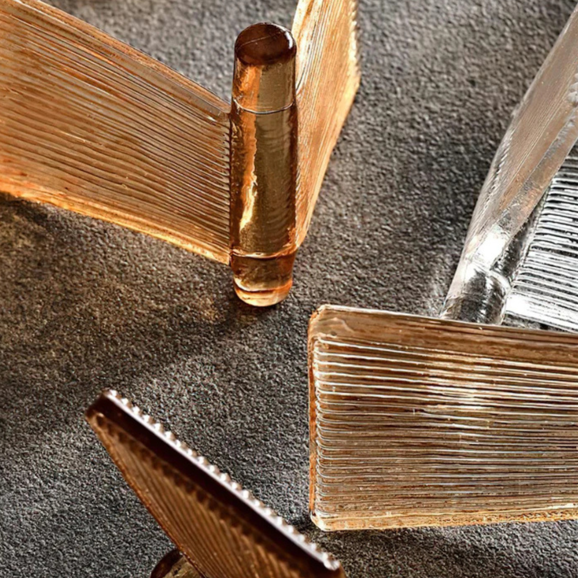 Close-up of ribbed glass light panels in amber and clear tones arranged in a layered design.