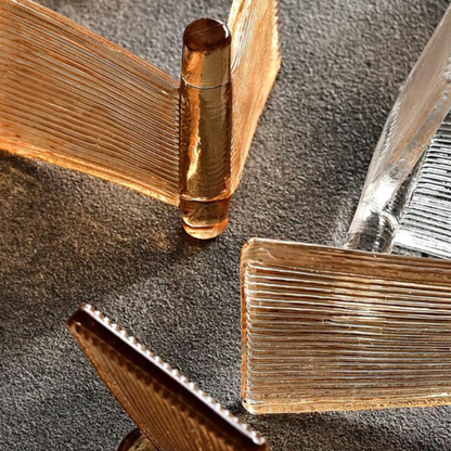 Close-up of ribbed glass light panels in amber and clear tones arranged in a layered design.