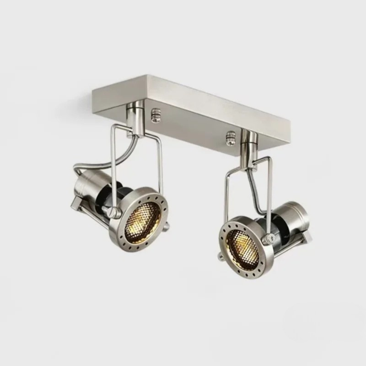 A brushed nickel double spotlight fixture mounted on a rectangular ceiling base with adjustable heads.