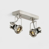 A brushed nickel double spotlight fixture mounted on a rectangular ceiling base with adjustable heads.