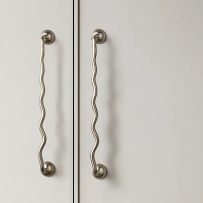 Wavy stainless steel cabinet handles installed on double doors