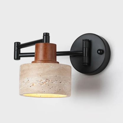 Close-up of a modern wall sconce with a black metal arm and a cylindrical stone-textured shade featuring a wooden accent.