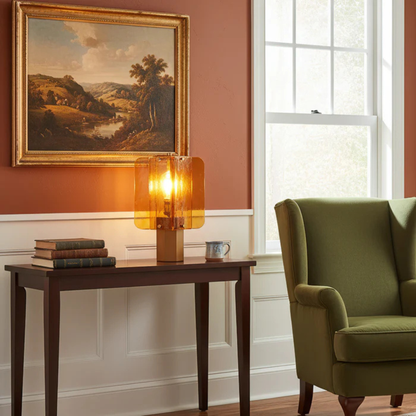 Living room with a green armchair, wooden table, and painting on the wall.