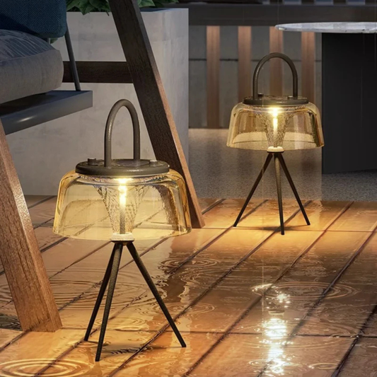 Modern tripod-style LED floor lamps with amber glass shades, providing warm ambient lighting for indoor or patio spaces