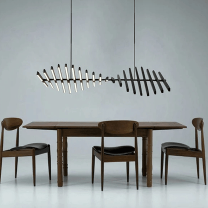 Dining table with chairs and a modern chandelier against a gray background