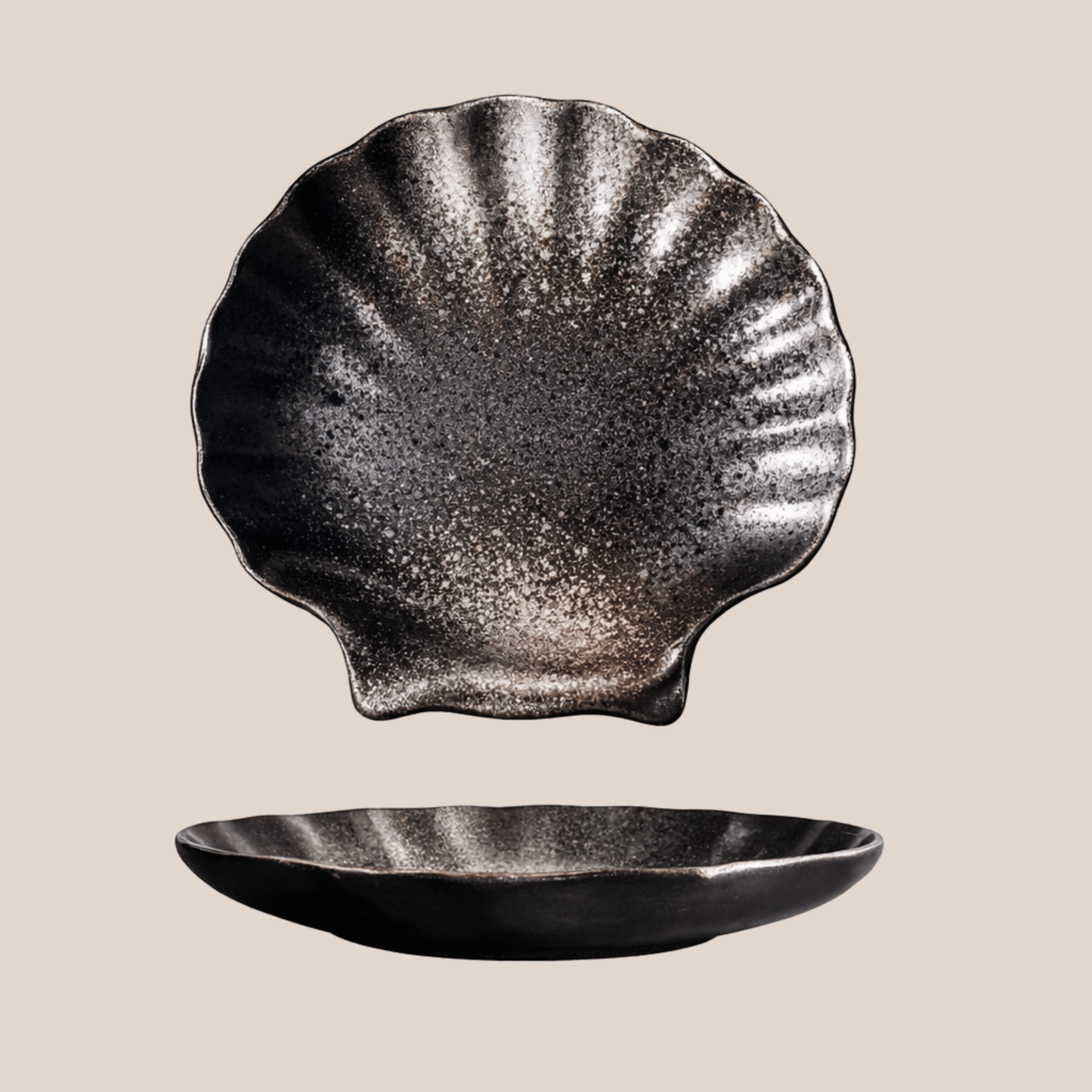 Black shell-shaped ceramic plate on a beige background