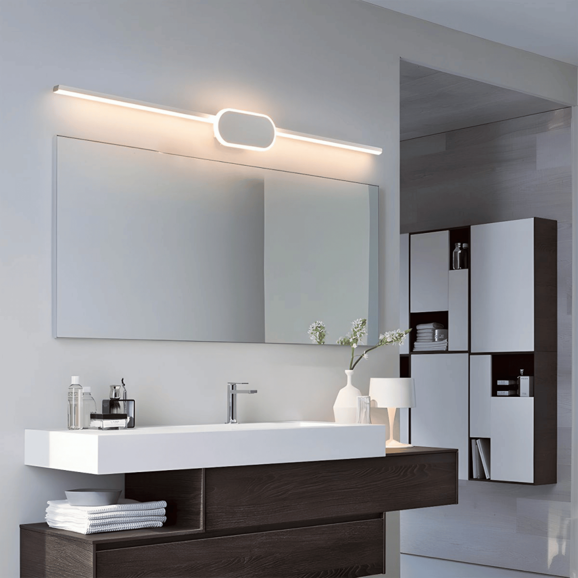 Modern bathroom vanity with mirror, lighting fixture, and decorative elements.