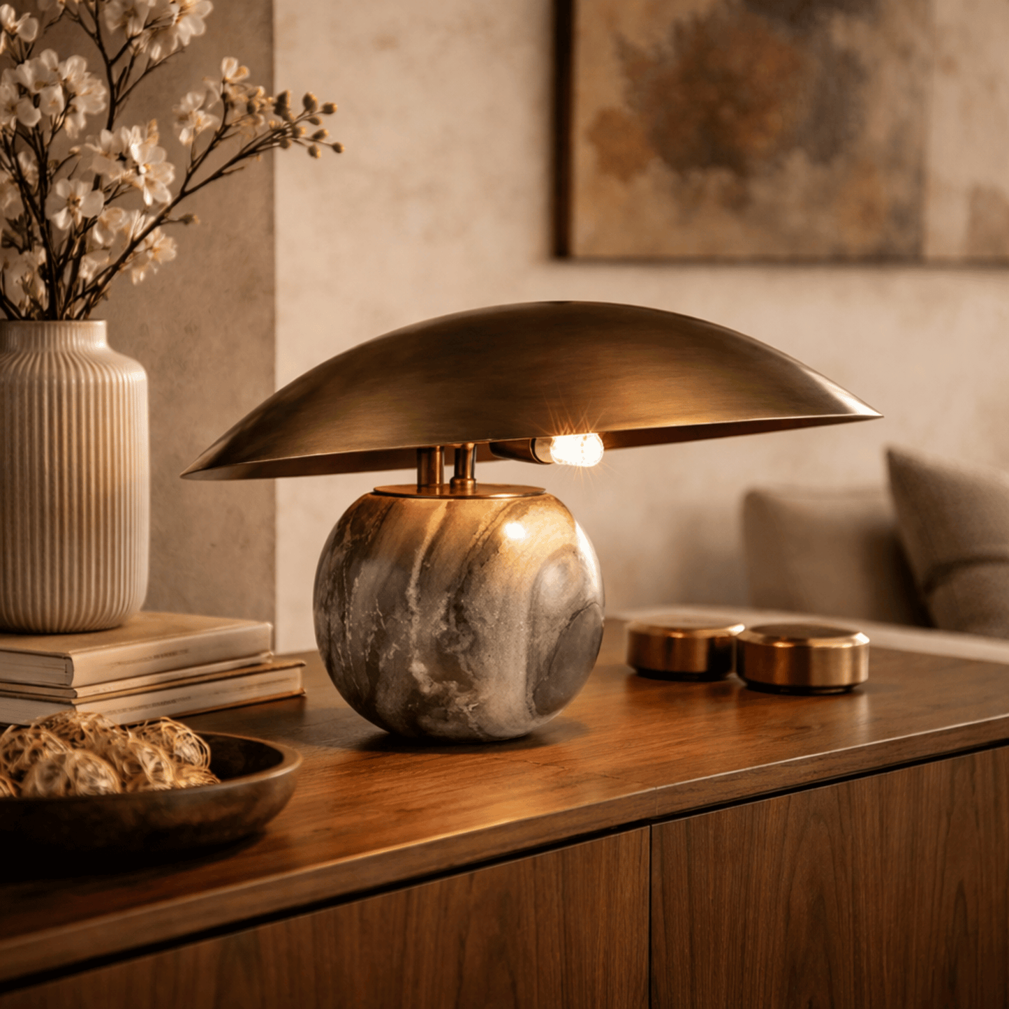 Decorative table lamp with marble base on a wooden surface in a home setting.