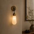 Wall-mounted light fixture with a warm glow on a neutral wall.