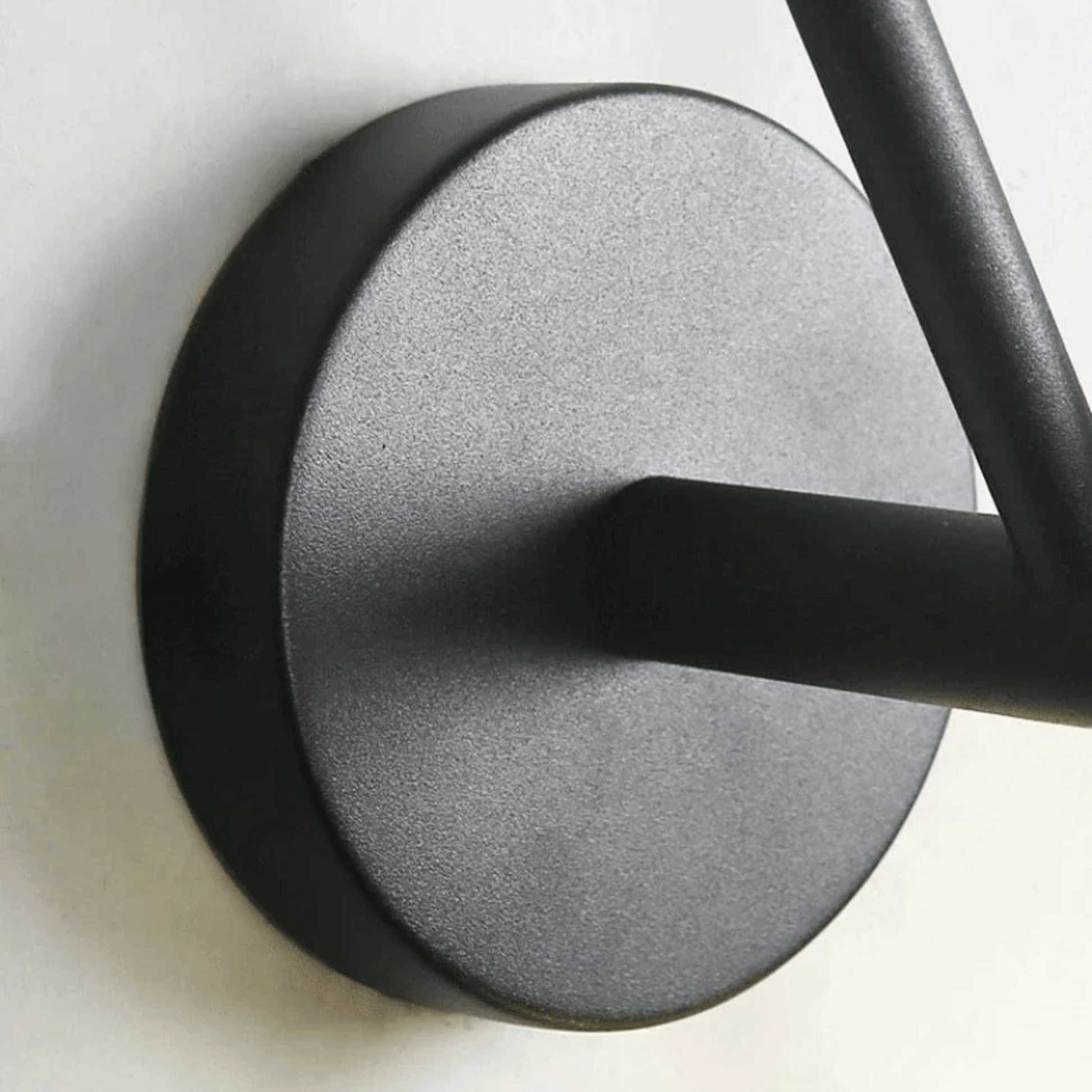 Close-up of a black door handle on a white background