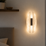 Wall-mounted light fixture on a neutral wall with a soft glow