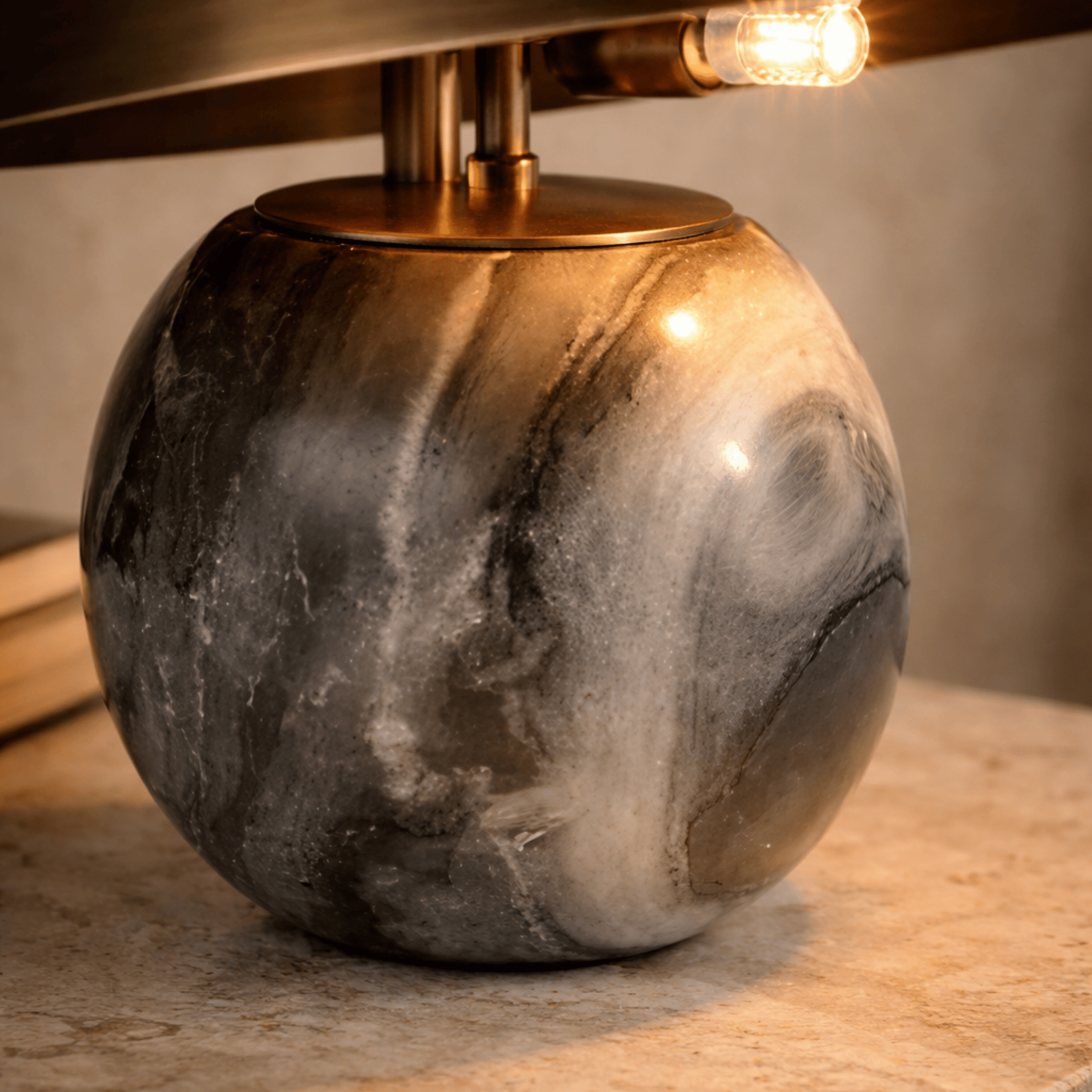 Marble-textured table lamp with a gold base on a wooden surface.