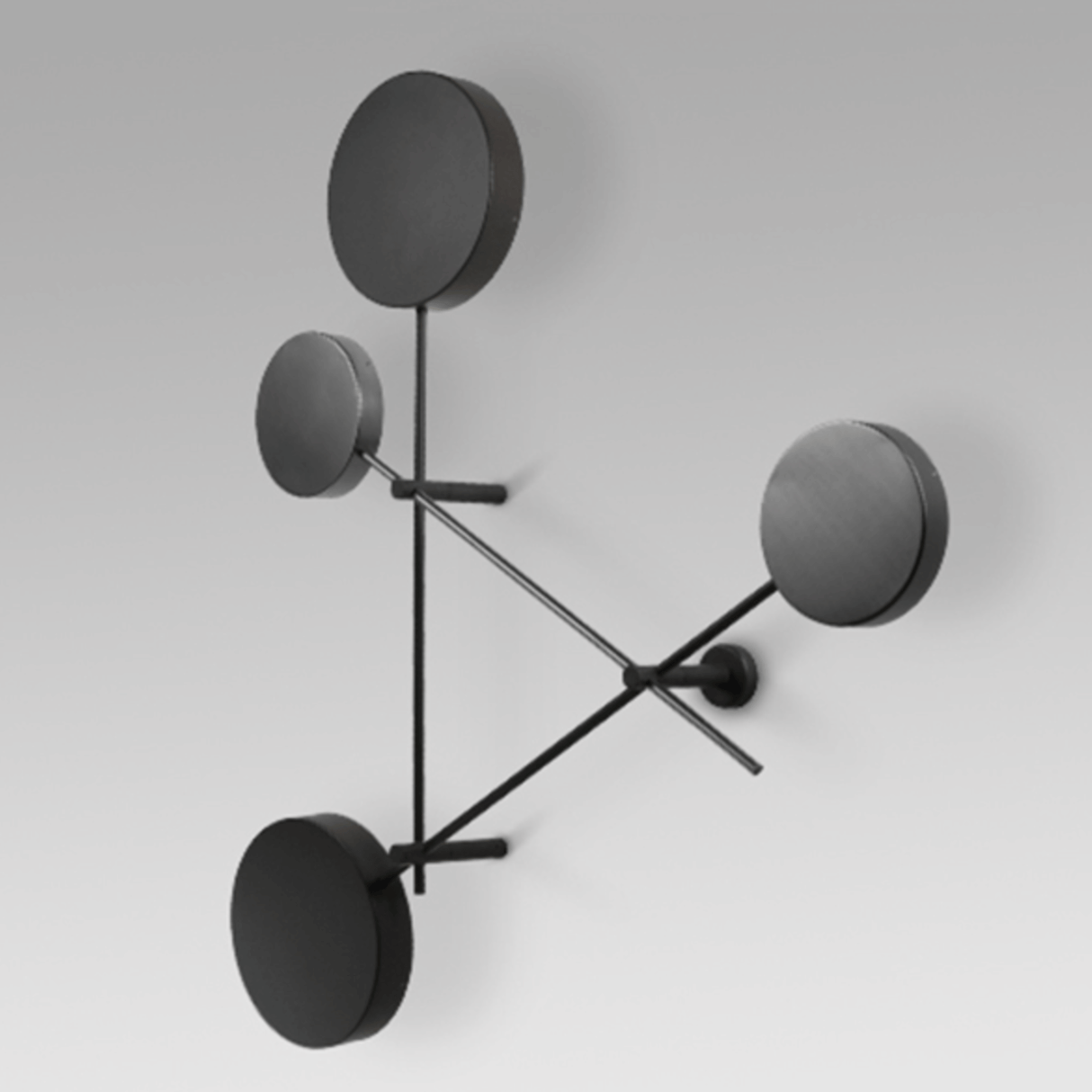 Modern wall lamp with four round black shades on a white background