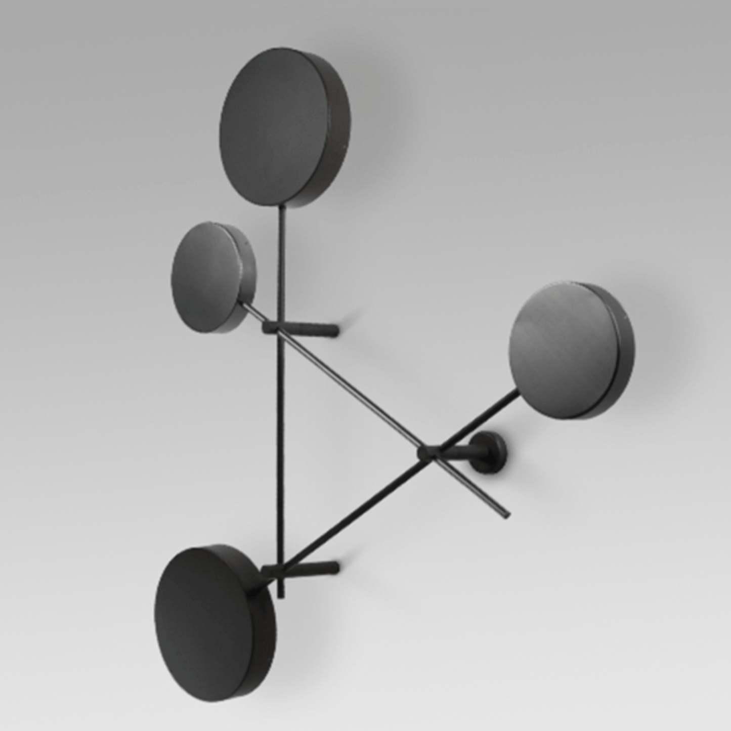 Modern wall lamp with four round black shades on a white background