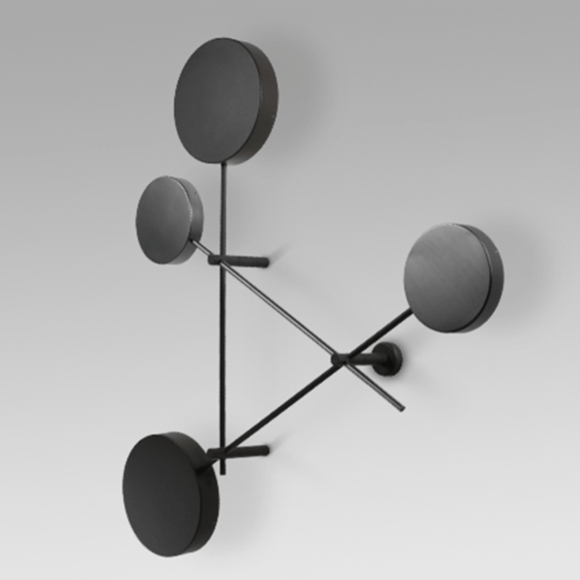 Modern wall lamp with four round black shades on a white background