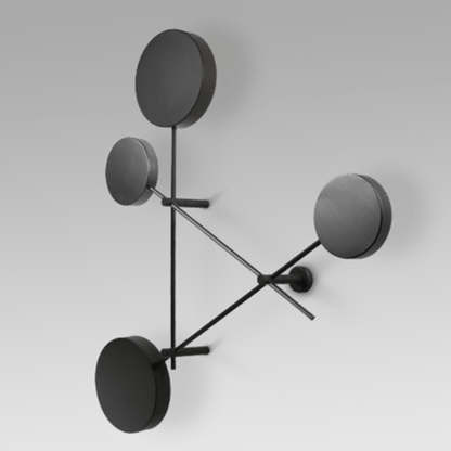 Modern wall lamp with four round black shades on a white background