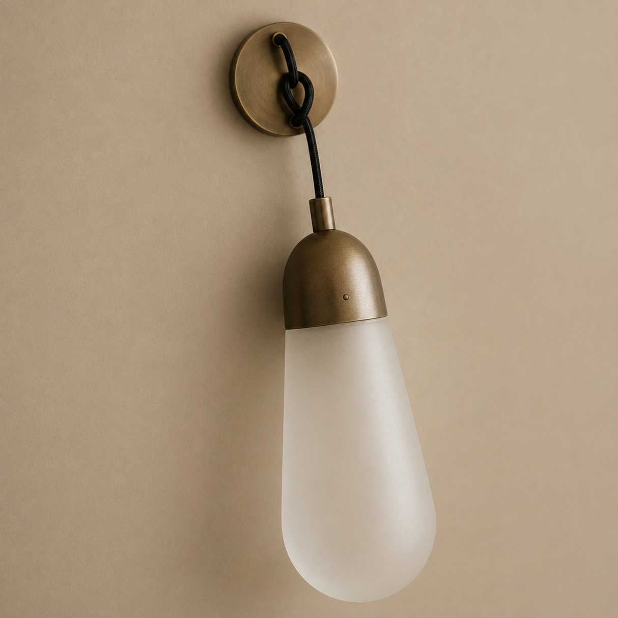 Wall-mounted light fixture with a vintage-style bulb on a beige background