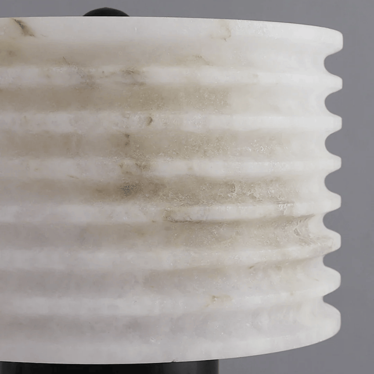 Close-up of a marble-textured vase against a gray background