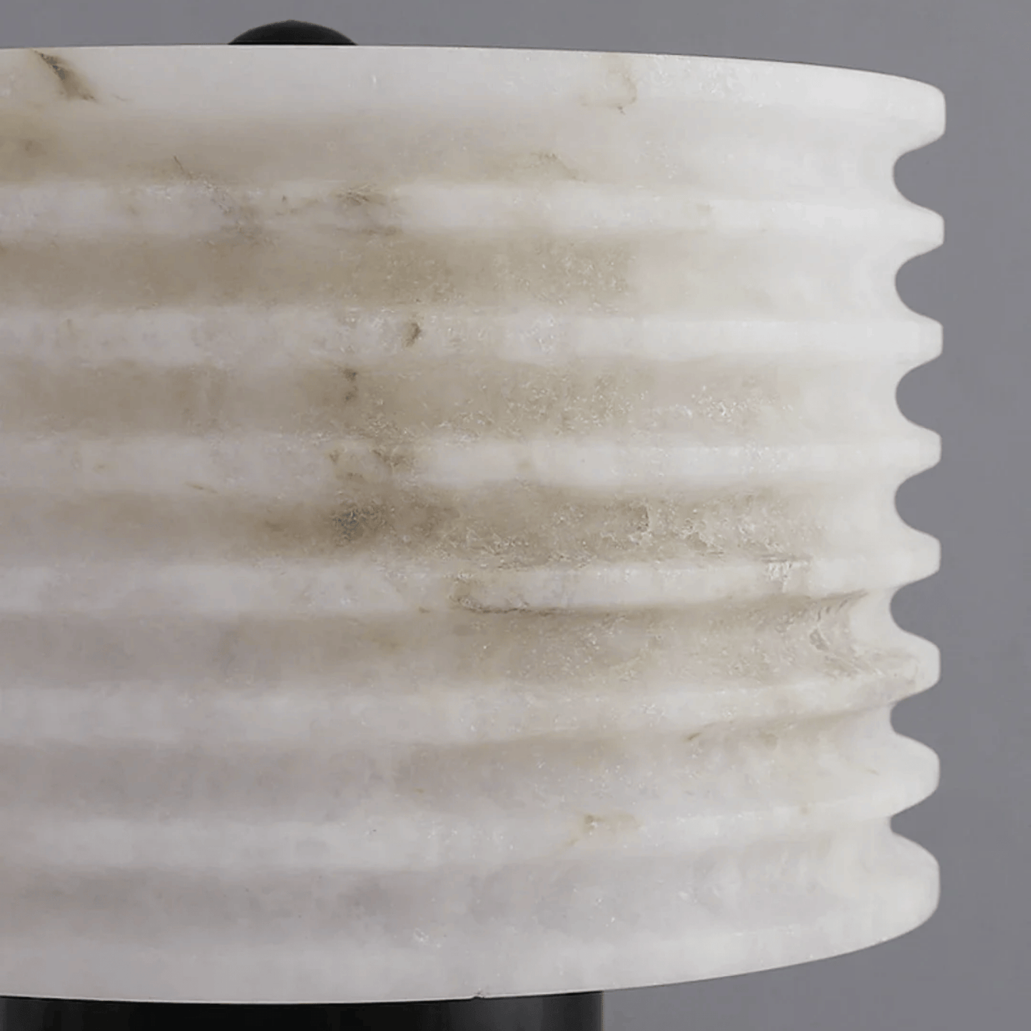 Close-up of a marble-textured vase against a gray background