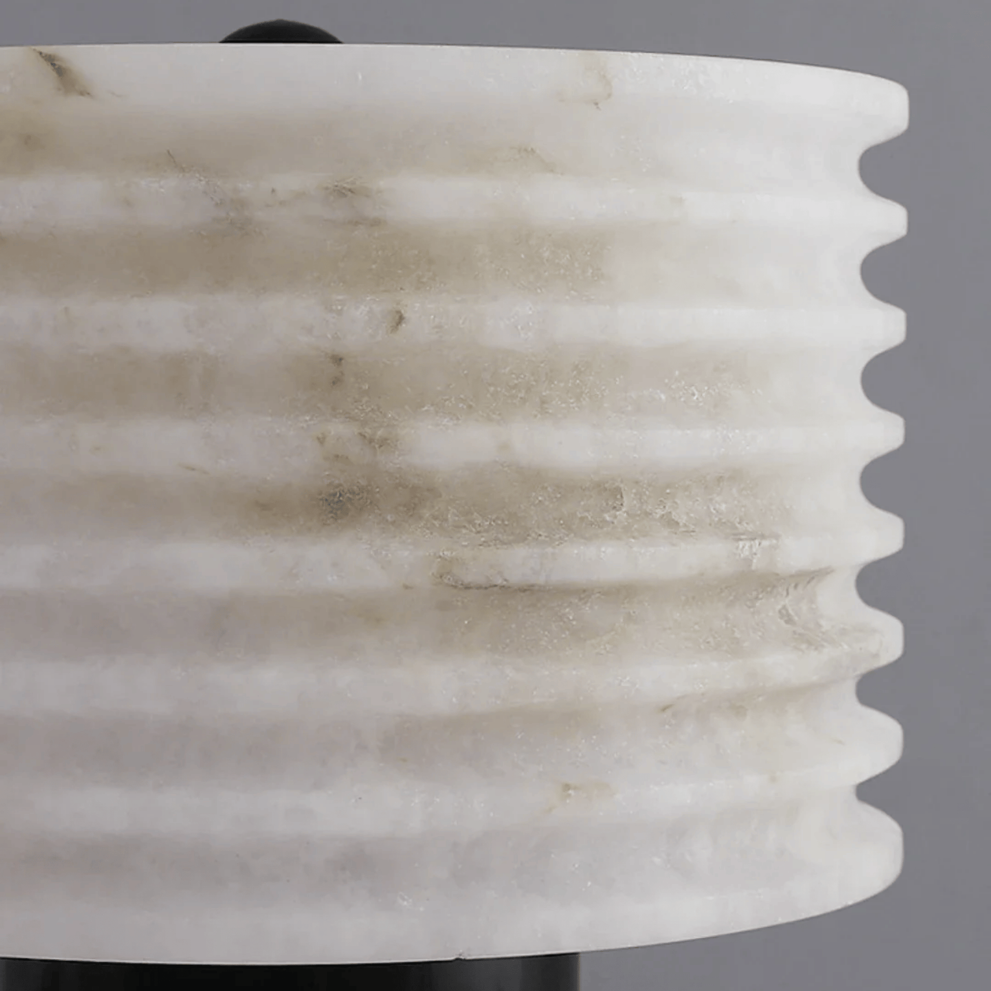 Close-up of a marble-textured vase against a gray background