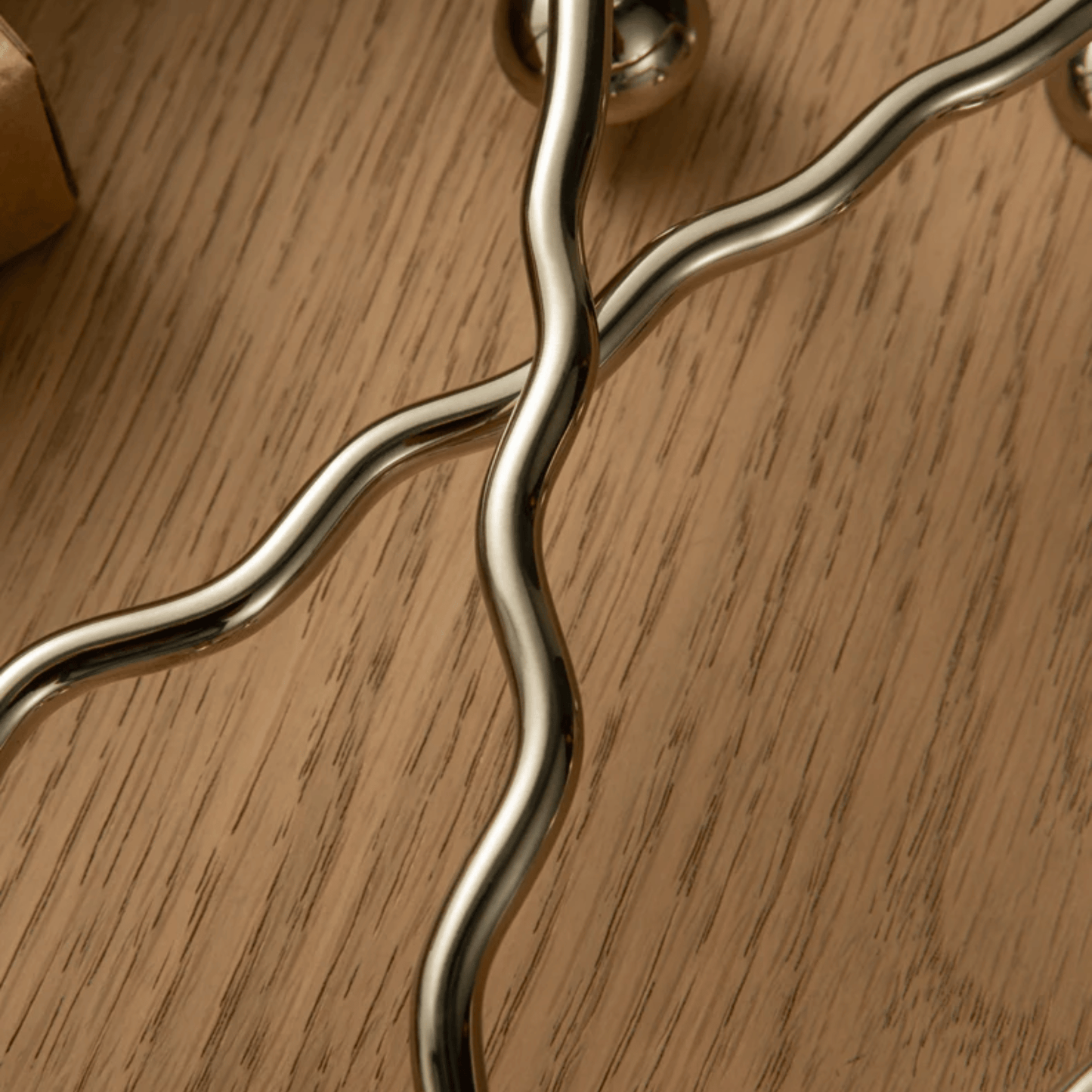 Metallic handle on a wooden surface
