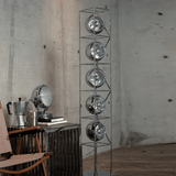 Metallic floor lamp with circular design elements in a room setting.