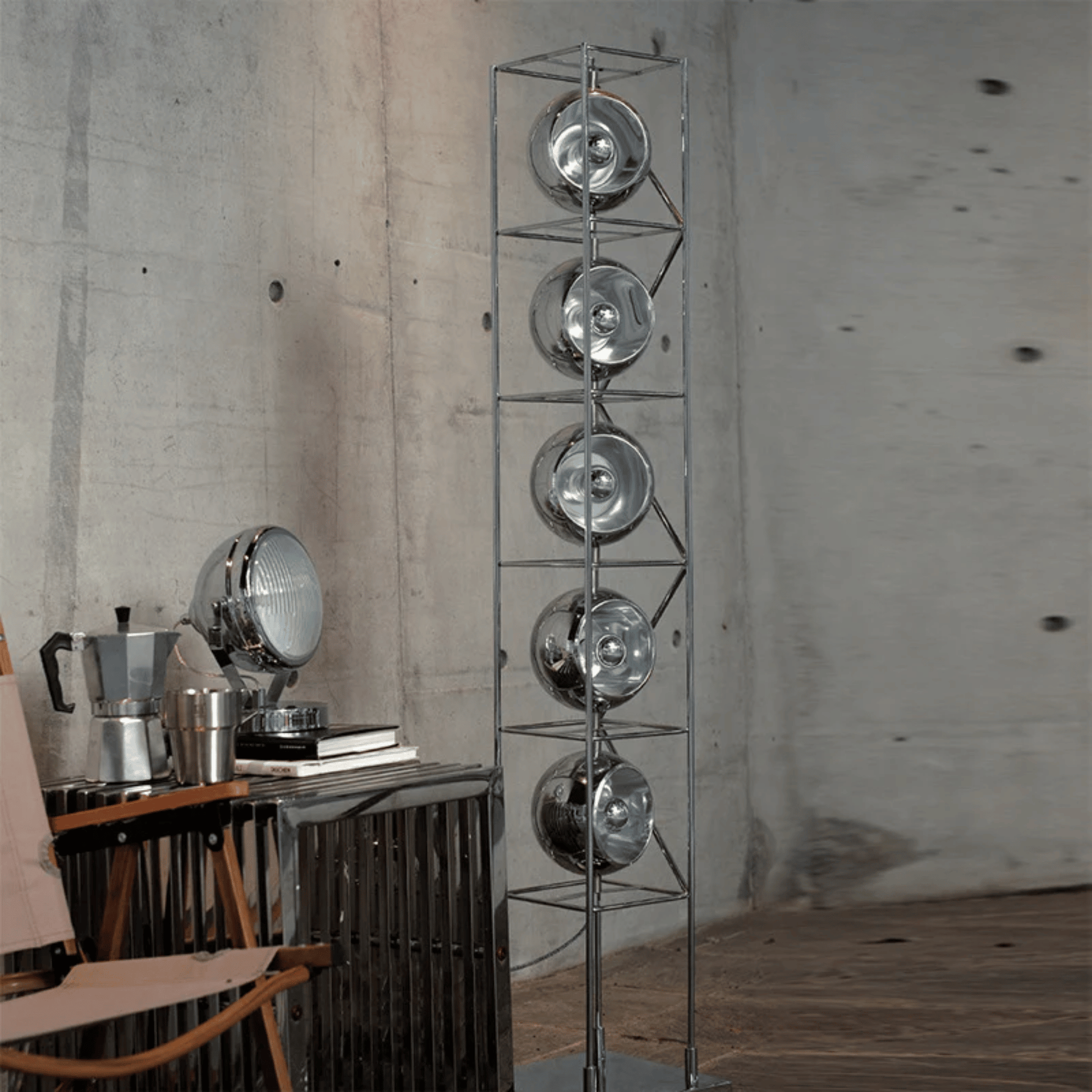 Metallic floor lamp with circular design elements in a room setting.