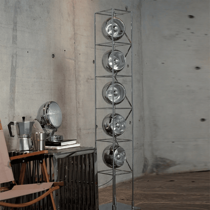 Metallic floor lamp with circular design elements in a room setting.