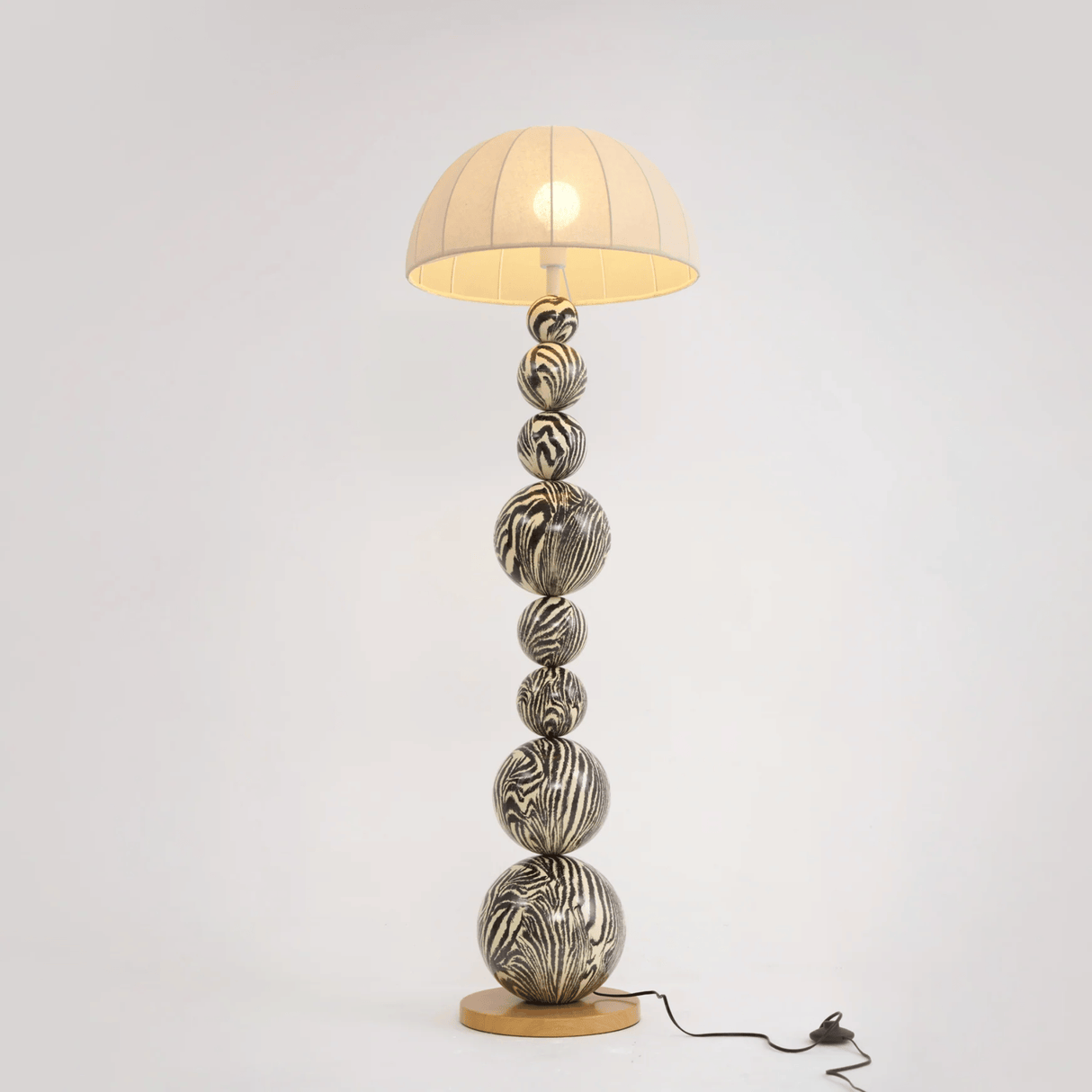 Decorative table lamp with unique base design on a white background