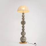 Decorative table lamp with unique base design on a white background