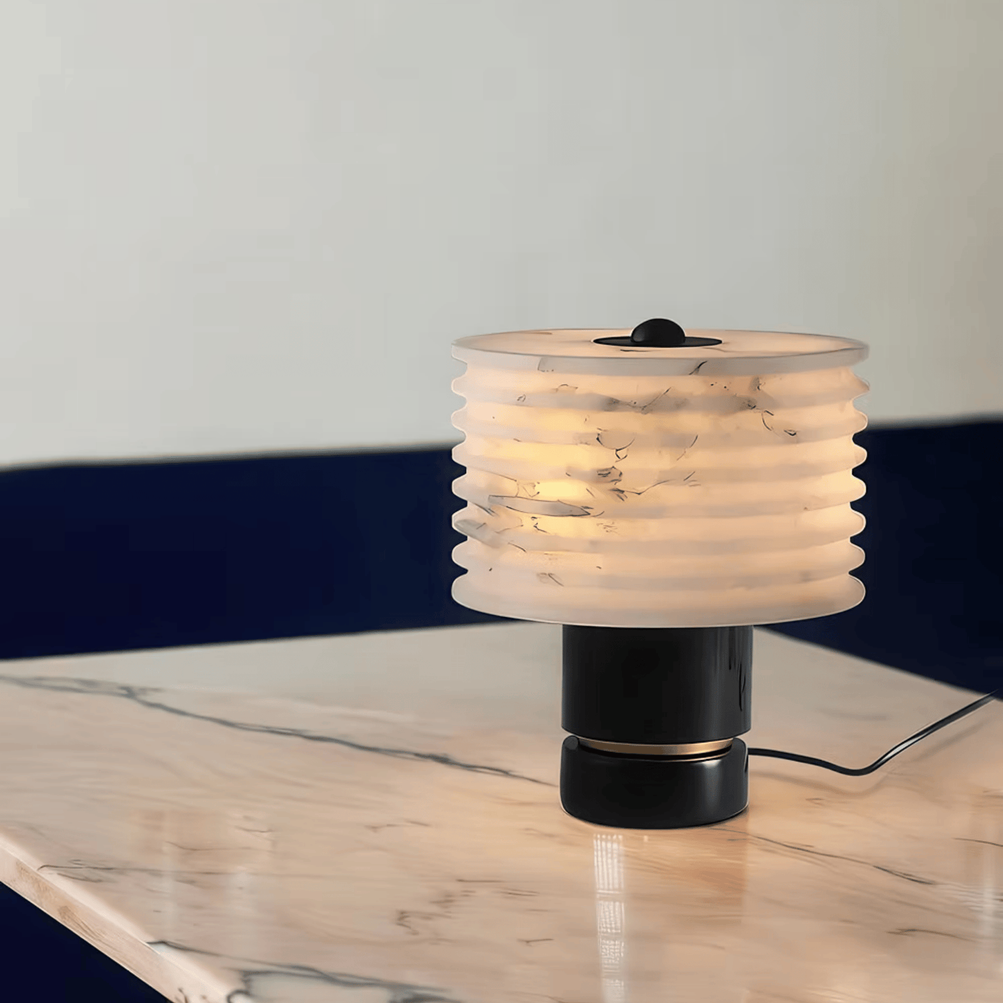 Table lamp with ribbed design on a marble surface