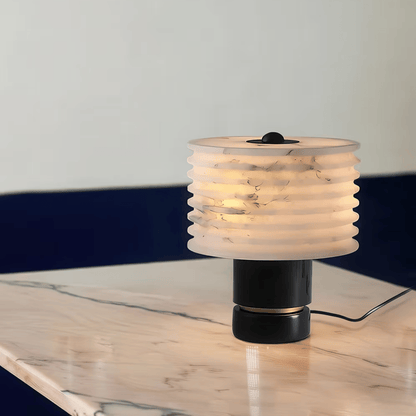 Table lamp with ribbed design on a marble surface