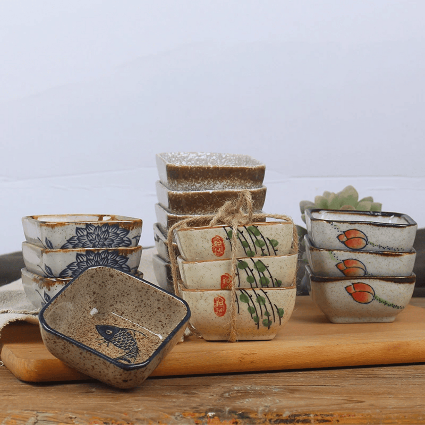 Set of ceramic bowls with various designs on a wooden surface