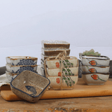 Set of ceramic bowls with various designs on a wooden surface
