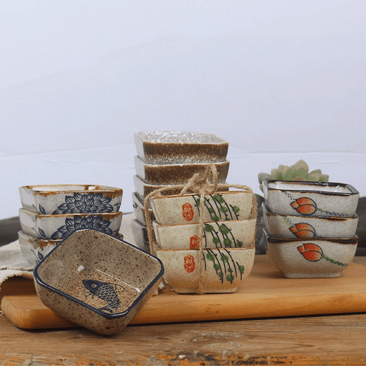 Set of ceramic bowls with various designs on a wooden surface