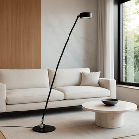 Modern living room with a white sofa, black floor lamp, and marble coffee table.