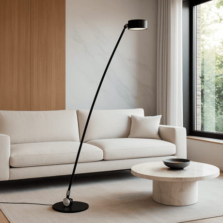 Modern living room with a white sofa, black floor lamp, and marble coffee table.
