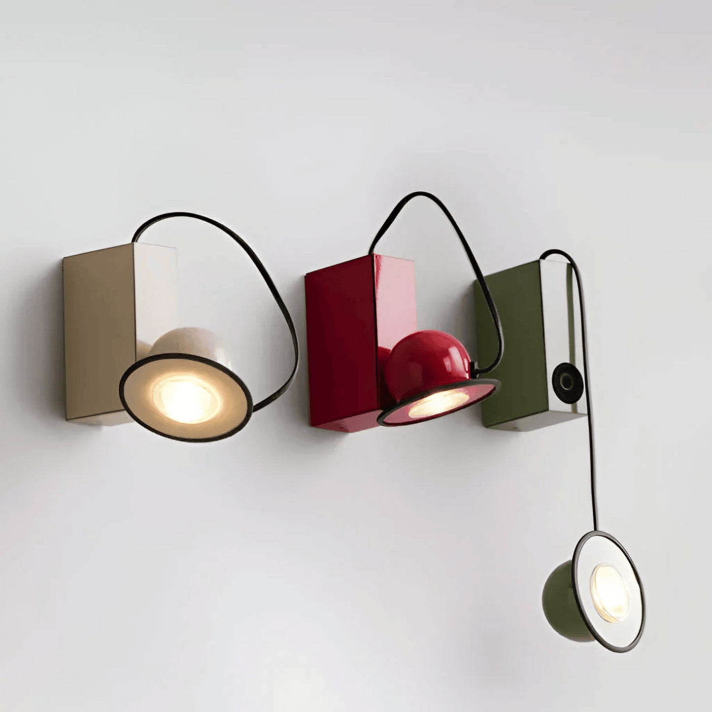 Modern wall-mounted light fixture with three different colored lights on a white background