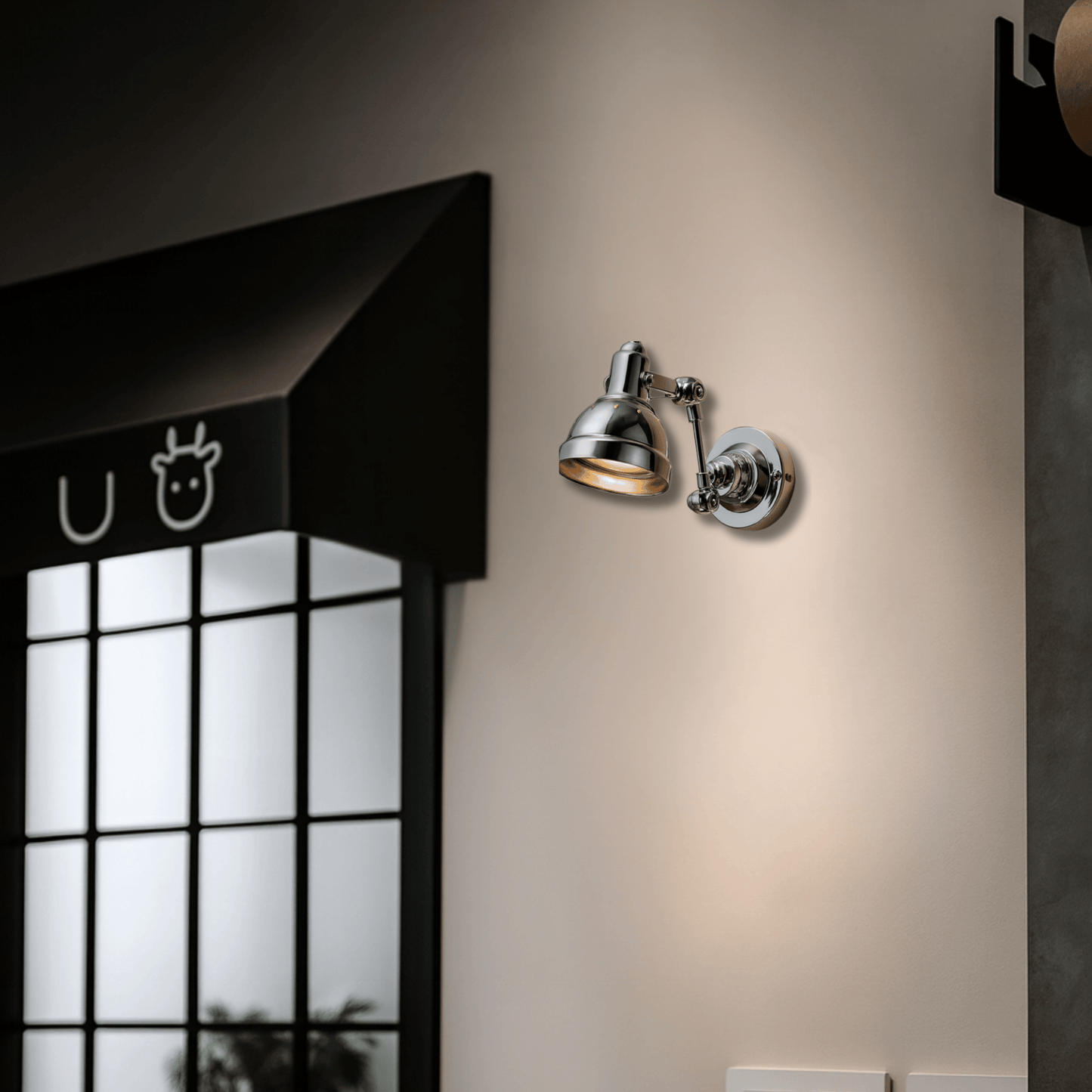 Wall-mounted lamp on a beige wall with a window and black awning in the background