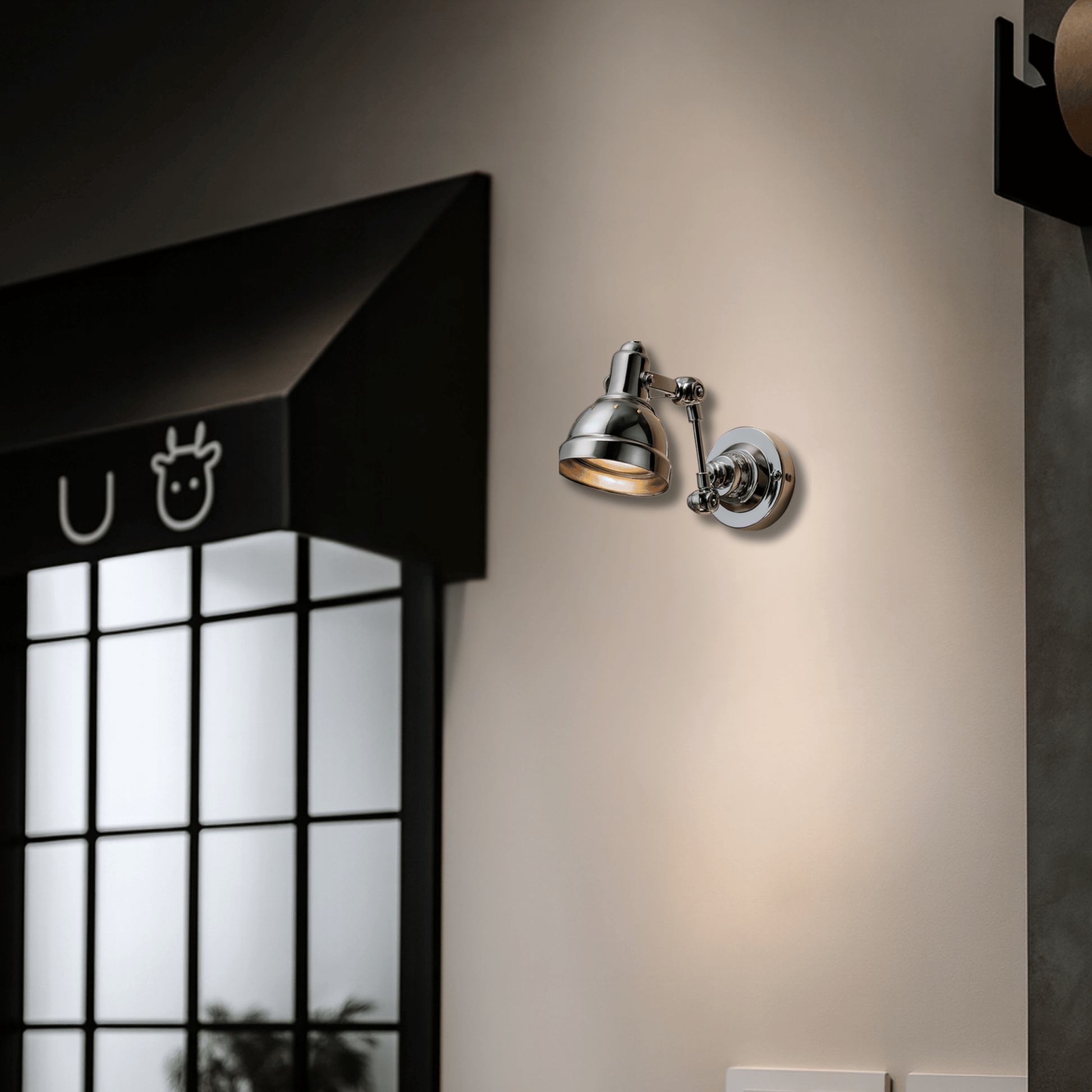 Wall-mounted lamp on a beige wall with a window and black awning in the background