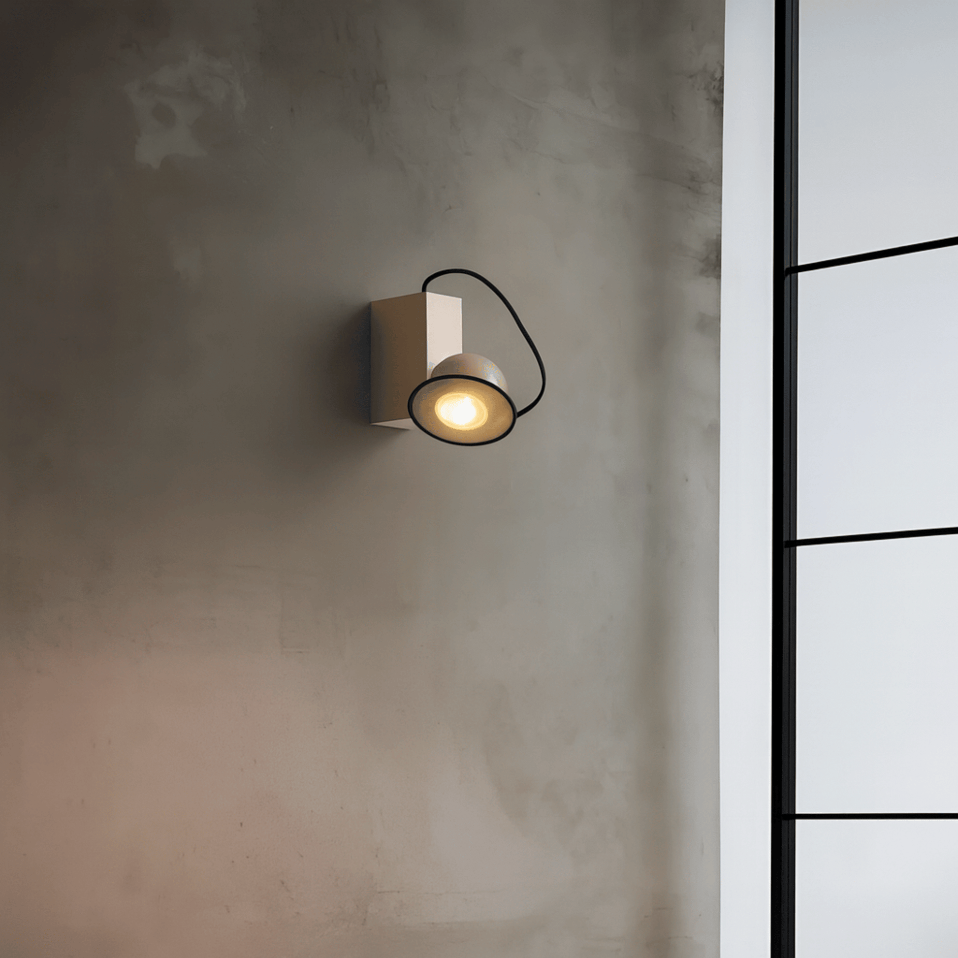 Wall-mounted light fixture on a textured wall with a window in the background