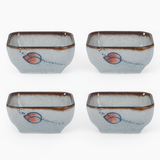 Four ceramic bowls with a decorative design on a white background