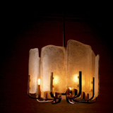 Modern chandelier with glass shades on a dark background